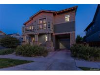 Charming two-story home with a stone-accented porch and balcony, plus a covered garage entrance at 8464 E 55Th Pl, Denver, CO 80238
