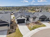Stunning exterior with landscaped yard and mountain views in a desirable community at 6586 S Lewis Ct, Littleton, CO 80127
