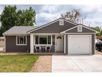Charming single-story home featuring a well-maintained lawn, a one-car garage, and inviting front porch seating at 8240 Grandview Ave, Arvada, CO 80002