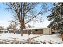 Brick ranch home with a snow-covered yard at 428 S Uvalda St, Aurora, CO 80012