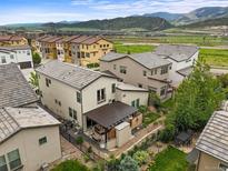 A beautiful backyard featuring a patio, garden, and well-maintained lawn with mountain views at 15547 W Vassar Ave, Lakewood, CO 80228