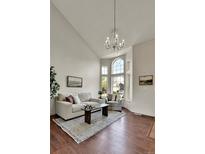 Bright living room with high ceilings, large windows, and stylish chandelier at 21455 E 44Th Ave, Denver, CO 80249