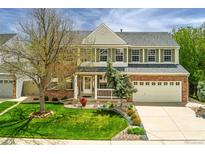 Charming two-story home featuring a brick facade, well-manicured lawn, and an attached two-car garage at 2822 Flint Ct, Superior, CO 80027