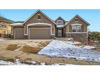 Charming home featuring stone accents, a three-car garage, and a well-maintained front yard at 461 Saber Creek Dr, Monument, CO 80132