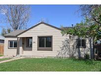 Charming single-story home with a well-maintained lawn and classic curb appeal in a residential neighborhood at 1750 Jamaica St, Aurora, CO 80010