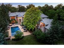 Stunning estate with mature trees, a swimming pool, an outdoor seating area, and meticulously manicured lawn at 850 E Radcliff Ave, Cherry Hills Village, CO 80113
