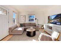 Bright living room features a comfortable sectional sofa, and neutral decor at 4920 Clay St, Denver, CO 80221