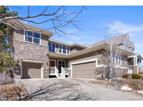 Charming home with brick accents, a two-car garage, and a cozy front porch for relaxing outdoors at 3431 Fantasy Pl, Castle Rock, CO 80109