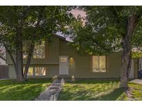 Well-maintained ranch home with updated siding, landscaping, and walkway at 18932 W 60Th Dr, Golden, CO 80403