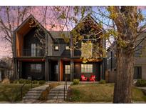 Modern two-story home with a black exterior, inviting front porch, and well-maintained lawn at 4454 Utica St, Denver, CO 80212