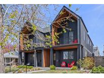 Modern black townhome with balconies and striking architectural details and lovely landscaping at 4454 Utica St, Denver, CO 80212