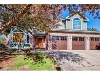 Charming brick home featuring a three-car garage and well-maintained landscaping with mature trees at 2345 Spotswood Pl, Boulder, CO 80304