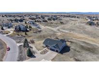 Spacious home with a three-car garage, large driveway, and landscaping in a serene neighborhood near open spaces at 14701 Yosemite St, Brighton, CO 80602