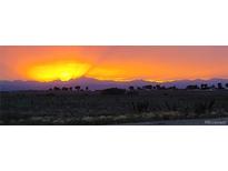 Scenic sunset view showcasing a mountain range and colorful sky at 14701 Yosemite St, Brighton, CO 80602