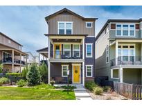 Charming two-story home with a well-manicured lawn and inviting yellow doors at 8958 Southurst St, Littleton, CO 80129