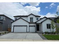 Beautiful two-story home with a two car garage, white siding and black trim on a sunny day at 2525 Lupton Ln, Lafayette, CO 80026