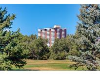 Residential high-rise with many floors is surrounded by green trees at 3131 E Alameda Ave # 1003, Denver, CO 80209