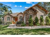 Stone and stucco exterior of a two-story house with landscaping at 8174 Inca Rd, Larkspur, CO 80118