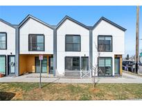 Contemporary townhome showcasing a modern design, clean lines, and inviting curb appeal on a sunny day at 1907 W Elk Pl # 4, Denver, CO 80211