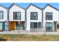 A modern townhome featuring sleek architecture and a well-manicured front yard at 1907 W Elk Pl, Denver, CO 80211