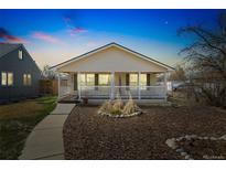 Charming home featuring a cozy front porch and well-maintained landscaping at 2019 S Fox St, Denver, CO 80223