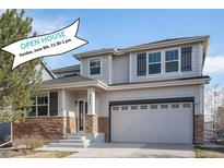 Charming two-story home with stone accents, a two-car garage, and a well-manicured lawn at 23841 E Alabama Dr, Aurora, CO 80018
