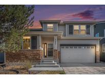 Charming two-story home with stone accents, well-maintained landscaping, and an attached two-car garage at 23841 E Alabama Dr, Aurora, CO 80018