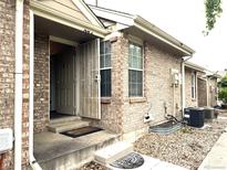 Charming brick home with a welcoming front entrance featuring a storm door for added security at 1470 S Quebec Way # 275, Denver, CO 80231