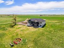 Expansive property featuring a modern farmhouse with a fire pit and beautiful country views at 2400 Ventress Ct, Bennett, CO 80102