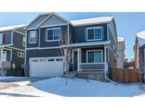 Two-story home featuring a front porch, two-car garage, neutral paint, and manicured landscaping in a suburban community at 17412 Rose Mallow St, Parker, CO 80134