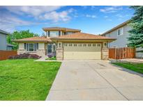 Charming two-story home featuring a well-manicured lawn and a spacious two-car garage at 2631 S Flanders Ct, Aurora, CO 80013