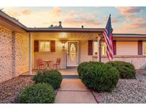 Charming home featuring a cozy front porch with a table and chairs, perfect for enjoying the outdoors at 12211 E Arkansas Pl, Aurora, CO 80012