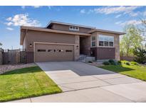 Beautiful home featuring a well-manicured lawn, a driveway, and an attached garage with paneled windows at 4000 Donnington Cir, Castle Rock, CO 80104