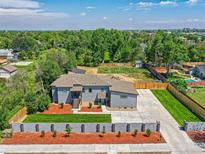 Beautifully landscaped front yard with a concrete driveway and lush green grass at 10197 E Mississippi Ave, Denver, CO 80247