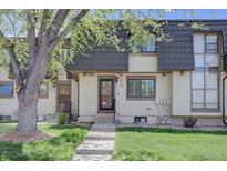 Charming townhome featuring a landscaped front yard and classic architectural details at 6844 S Broadway, Littleton, CO 80122