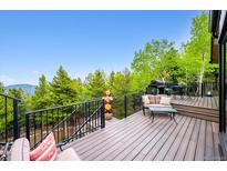Relax on this back deck with beautiful views and a grill for outdoor cooking at 11094 Thomas Dr, Conifer, CO 80433