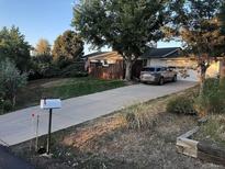 Charming home featuring a long driveway and a well-maintained lawn at 1530 Whippoorwill Dr, Lakewood, CO 80215