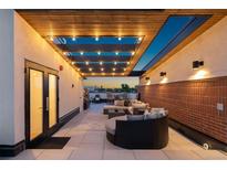 Inviting rooftop deck with stylish seating, ambient lighting, and scenic views for relaxation and entertainment at 485 E Arizona Ave, Denver, CO 80210