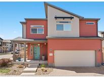 Modern two-story home showcasing a stylish facade, garage, and a quaint front porch at 4125 Coriander St, Castle Rock, CO 80109