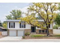 Charming home featuring a well-maintained yard, a two-car garage, and a classic exterior design at 12680 W 38Th Dr, Wheat Ridge, CO 80033
