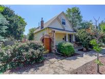 Charming exterior with a decorative brick and wood gate and beautiful landscaping at 4032 Lipan St, Denver, CO 80211