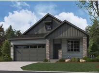 Charming home featuring vertical siding, brick accents, and a well-manicured lawn at 13826 Honey Hush Trl, Parker, CO 80134