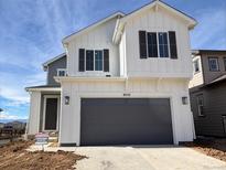 Charming two-story home with a two-car garage and modern farmhouse-style facade at 9257 Truckee Ct, Commerce City, CO 80022