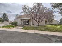 Charming home featuring a covered entrance, inviting curb appeal, and a beautifully landscaped front yard at 2694 S Xanadu Way # D, Aurora, CO 80014