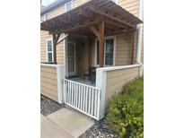 Charming front porch with a pergola and a white gate for added privacy and curb appeal at 8452 Everett Way # C, Arvada, CO 80005