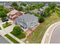 Spacious home with a fenced backyard, lush greenery, and a neatly manicured lawn at 16120 E 119Th Ave, Commerce City, CO 80022