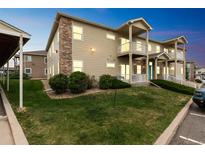 Charming townhouse with brick accents, balconies, and well-maintained landscaping at 1771 W 53Rd Pl # 2, Denver, CO 80221