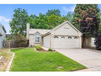 Charming home with a well-manicured front lawn and an attached two-car garage in a quiet neighborhood at 17692 E Brunswick Pl, Aurora, CO 80013