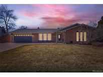 Charming brick home featuring a well-manicured front yard and an attached two-car garage at 6342 W Fremont Dr, Littleton, CO 80128