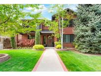 Two-story brick home with manicured lawn, mature trees, and a welcoming front entrance at 2153 S Columbine St, Denver, CO 80210